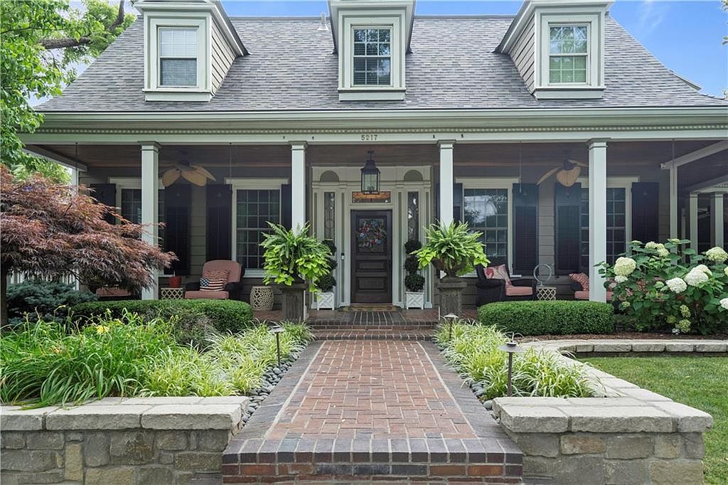 Iconic 1925 Mission, Kansas Home With Wraparound Porch, Dual Primary Suites, Waterfall Wet Bar, and Resort-Style Pool