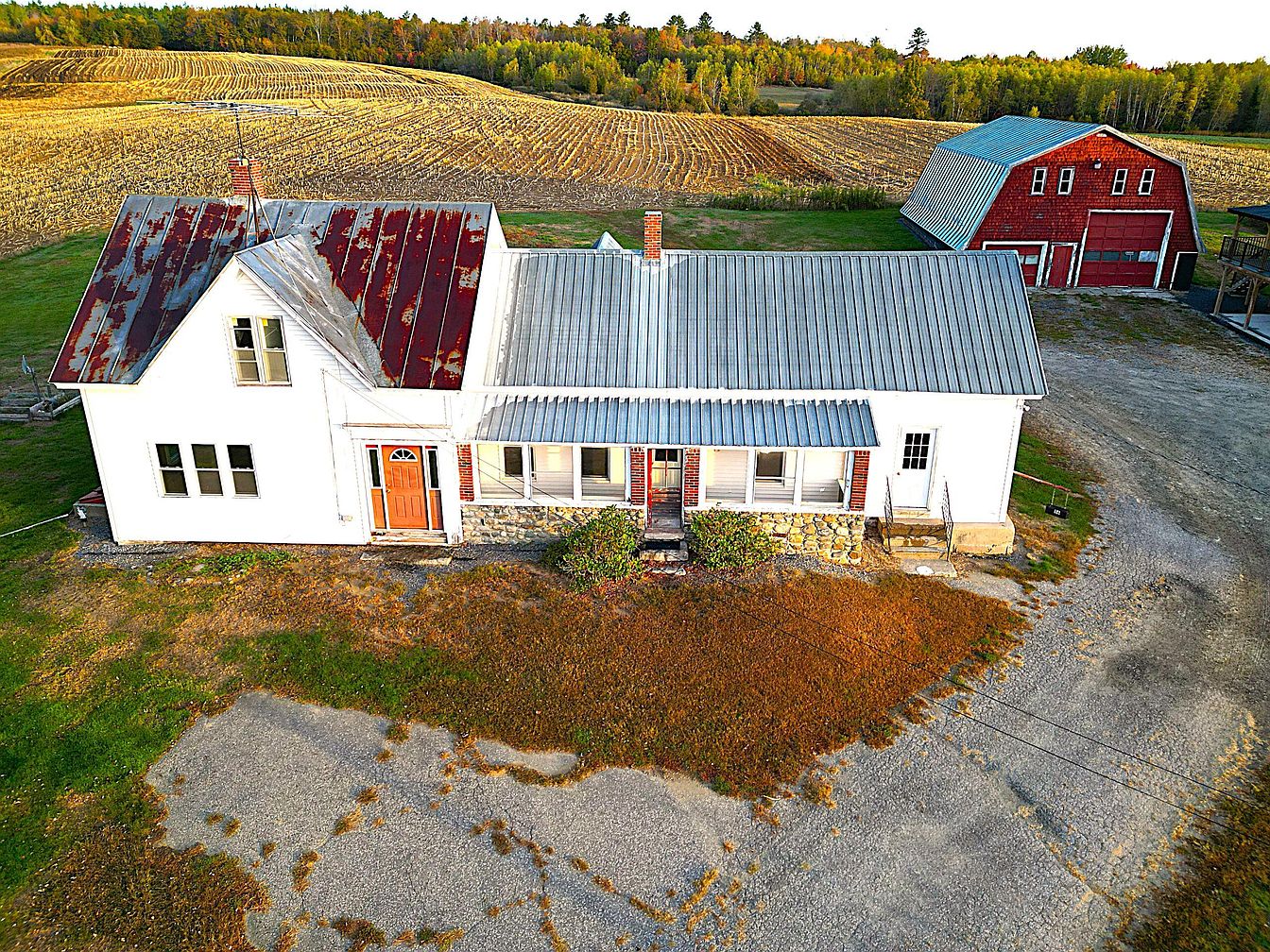 Explore a 1918 Farmhouse in Madison, Maine With Three Barns, a Second Home, Grain Silo, and 270 Acres of Wooded Land