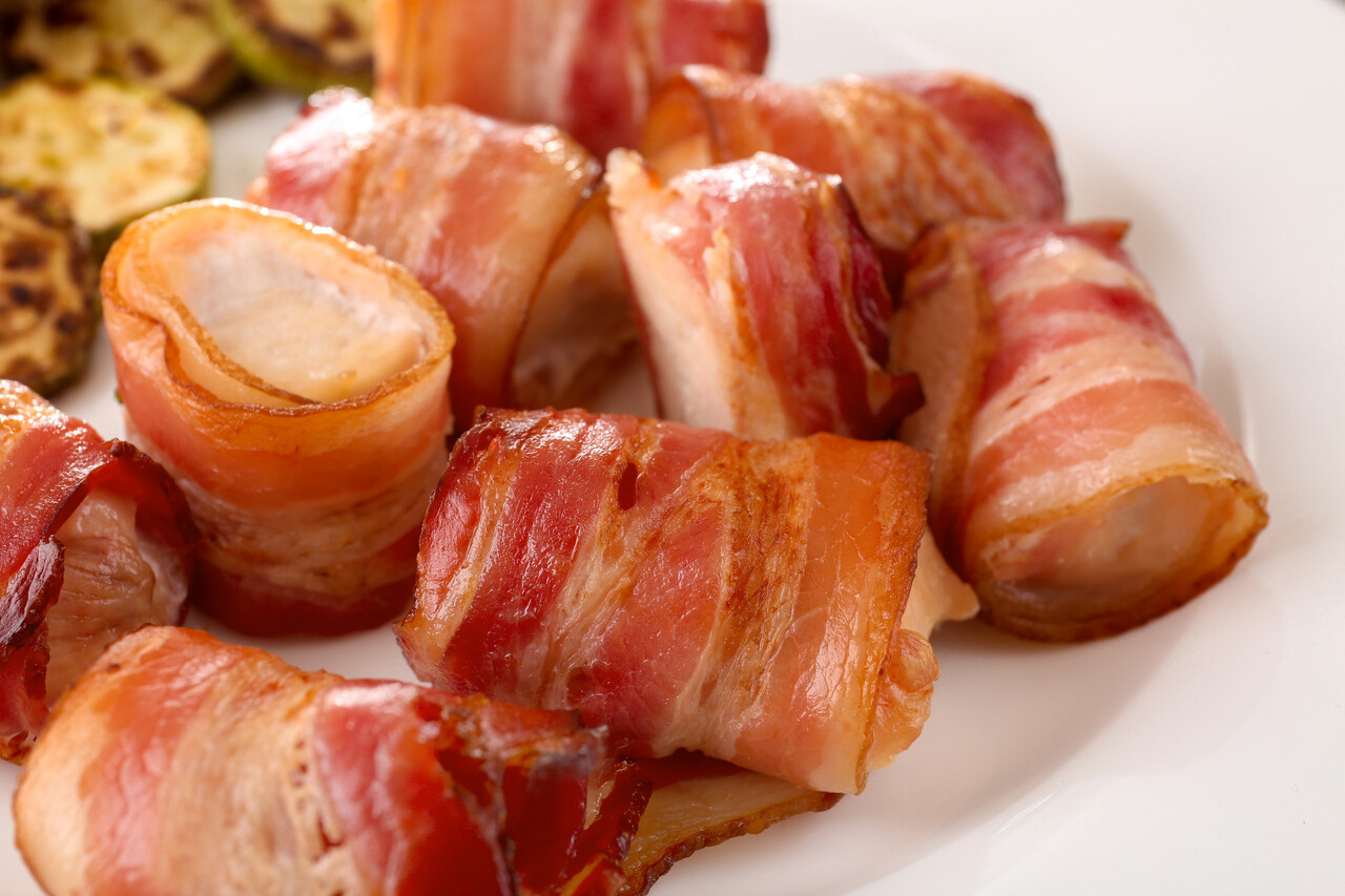 Plate with bacon wrapped chicken nuggets, closeup