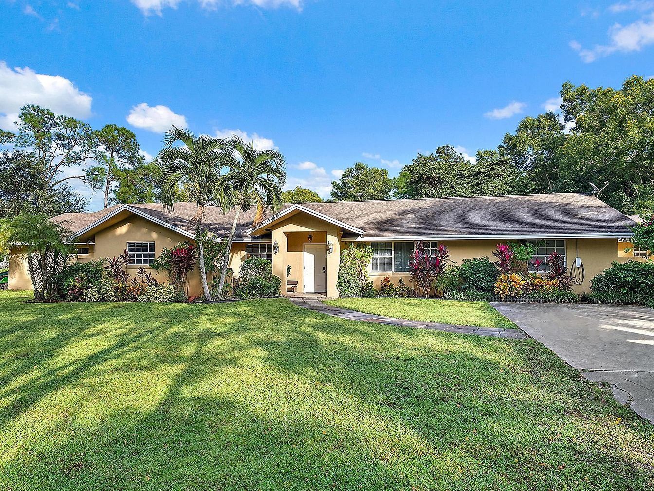 Historic 1977 Modern Oasis in Jupiter, Florida, with a Massive Solar-Heated Pool, Custom Cabinetry, and a Backyard Orchard