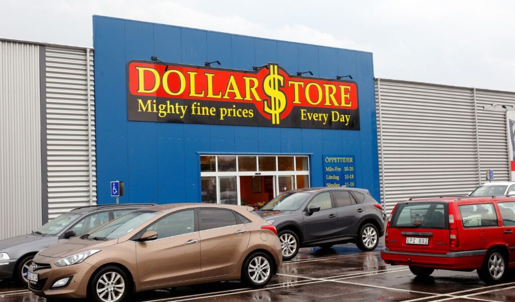 Car parking outside the Dollar Store discount store entrance.