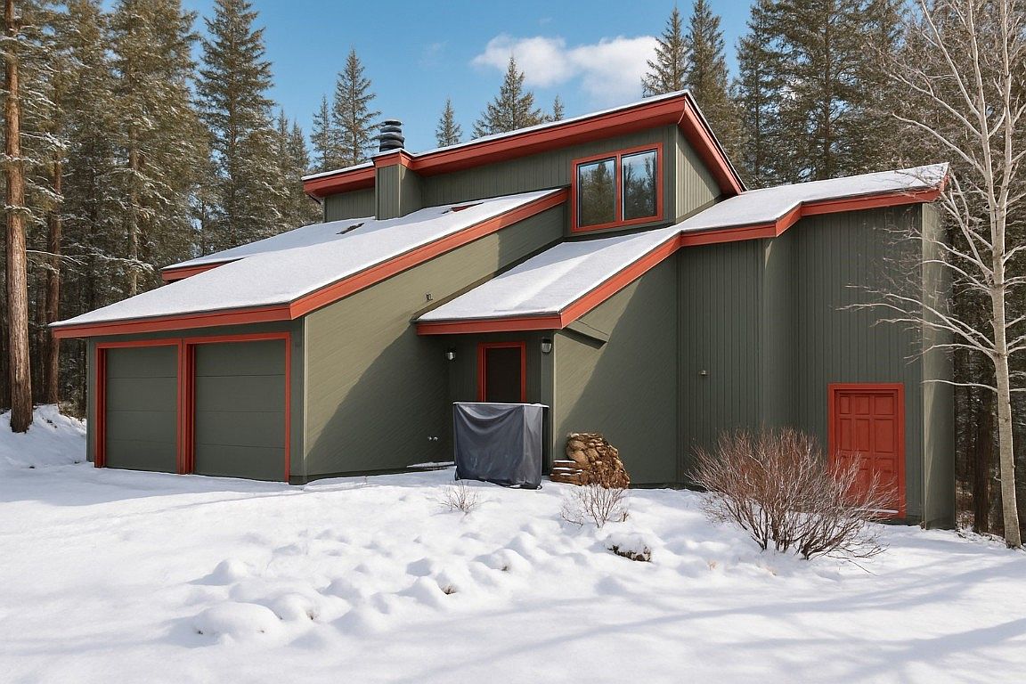 Serene 1981 Mountain Retreat in Breckenridge, Colorado with Vaulted Ceilings, Stunning Windows, and a Wraparound Deck