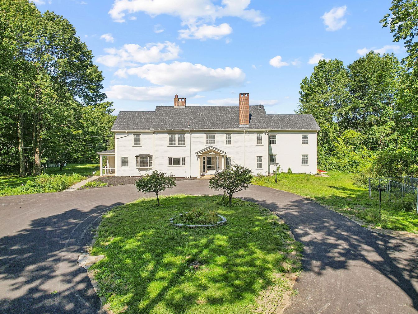 Unveil a 1918 Colonial Estate in Falmouth, Maine, Nestled on 13 Acres with a Barn, In-Ground Pool, and a Two-Story Library
