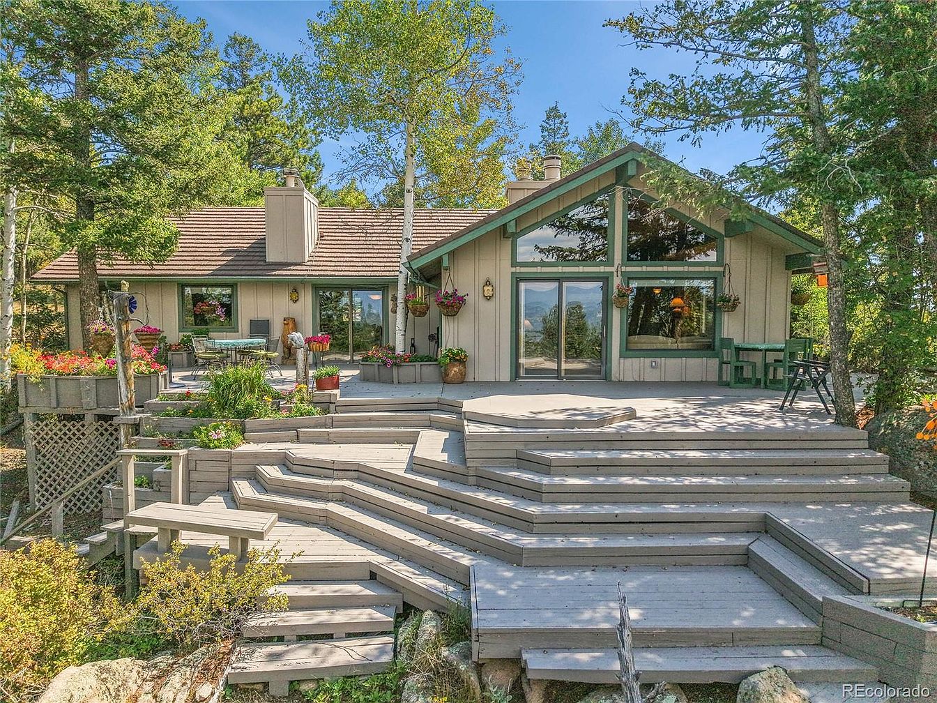 Serene 1974 Mountain Retreat in Evergreen, Colorado, Featuring Snowcapped Views, a Spacious Kitchen, and Outdoor Spaces