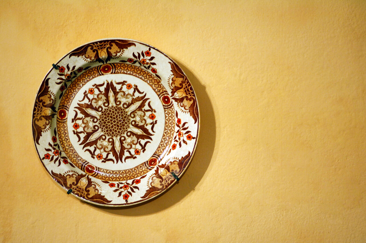 decorative plate on a yellow wall