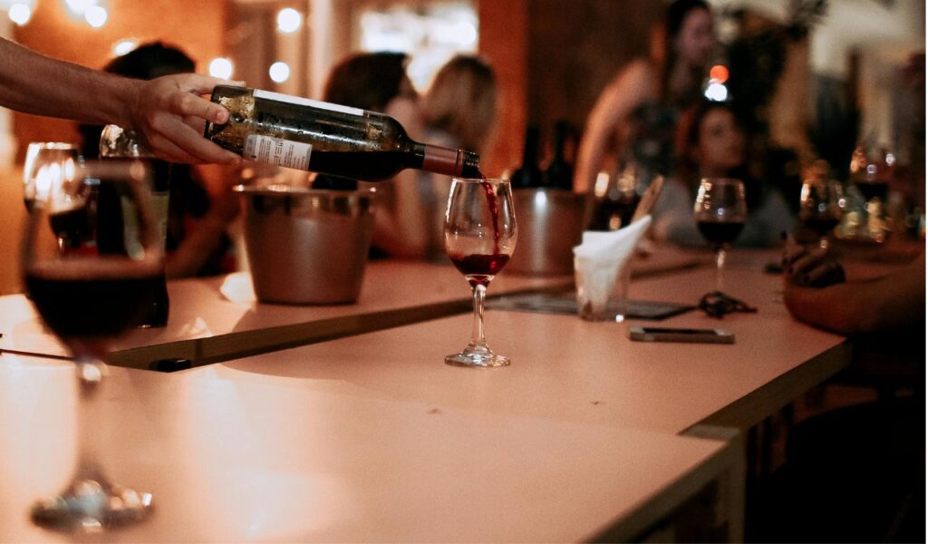 Liquor pouring in glass at food table