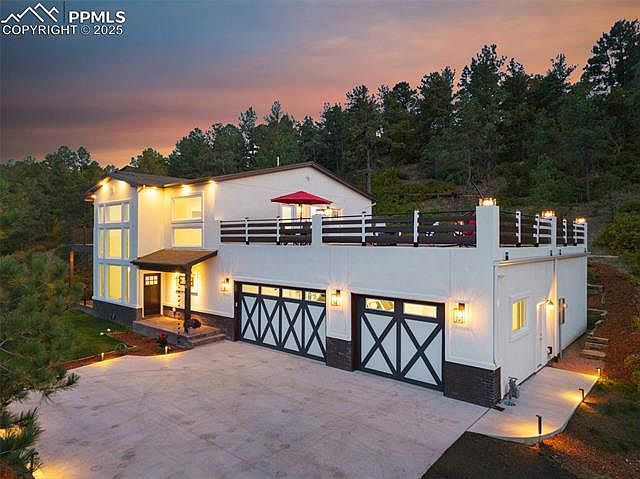 Experience Modern Elegance in Colorado Springs, Featuring Panoramic Views of Blodgett Peak and a Graceful Curved Staircase