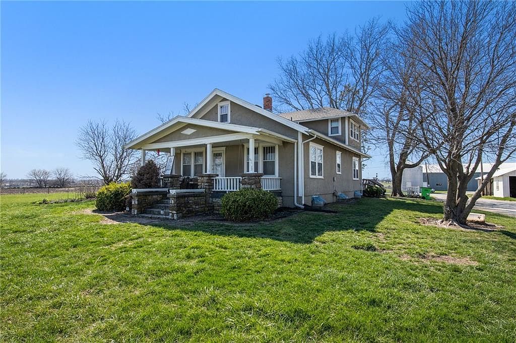 Explore a 1920 Farmhouse in Edgerton, Kansas, with 160 Acres of Agricultural Potential, Two Large Barns, and a Pond Oasis