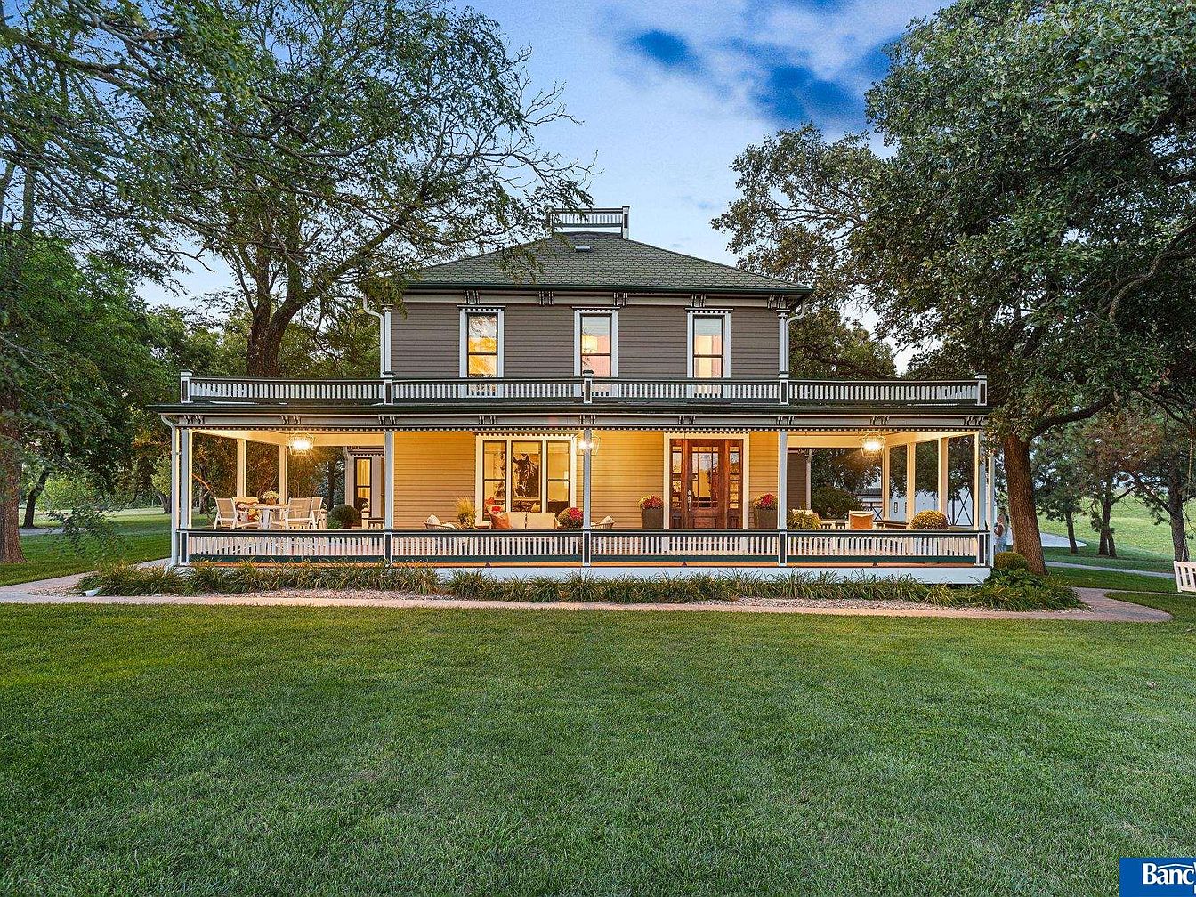 Visit This Elegant 1900 Estate in Hickman, Nebraska, Featuring 7 Bedrooms, 4 Fireplaces, and a Stunning One-Acre Pond