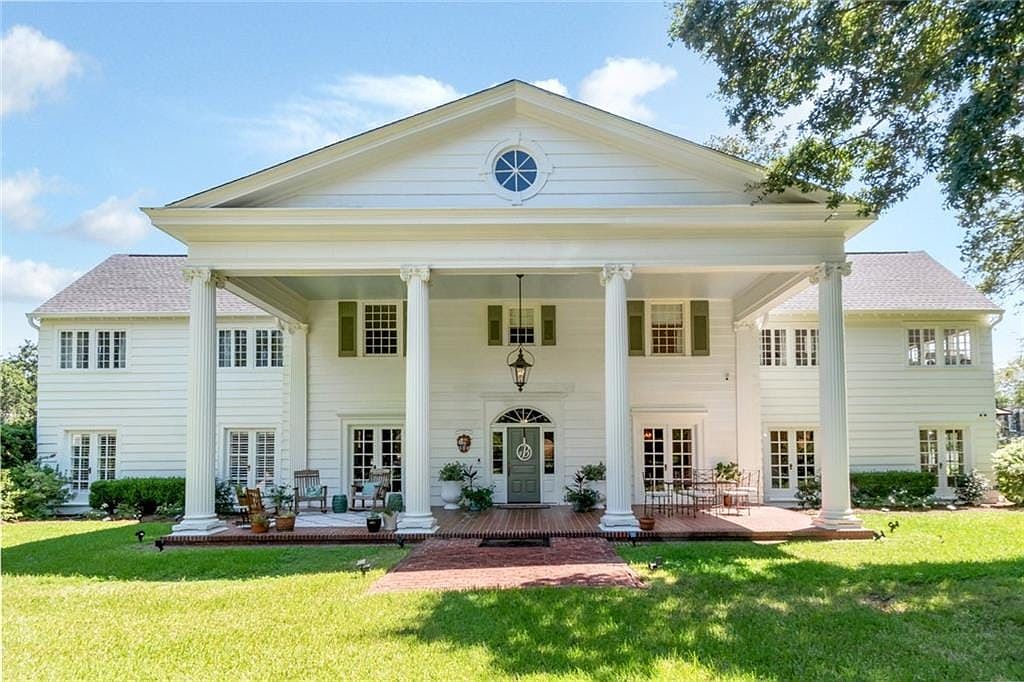 Visit 1927 Colonial in Mobile, Alabama, Featuring Modern Upgrades, Living Spaces, and a 0.8-Acre Lot with Majestic Oak Trees