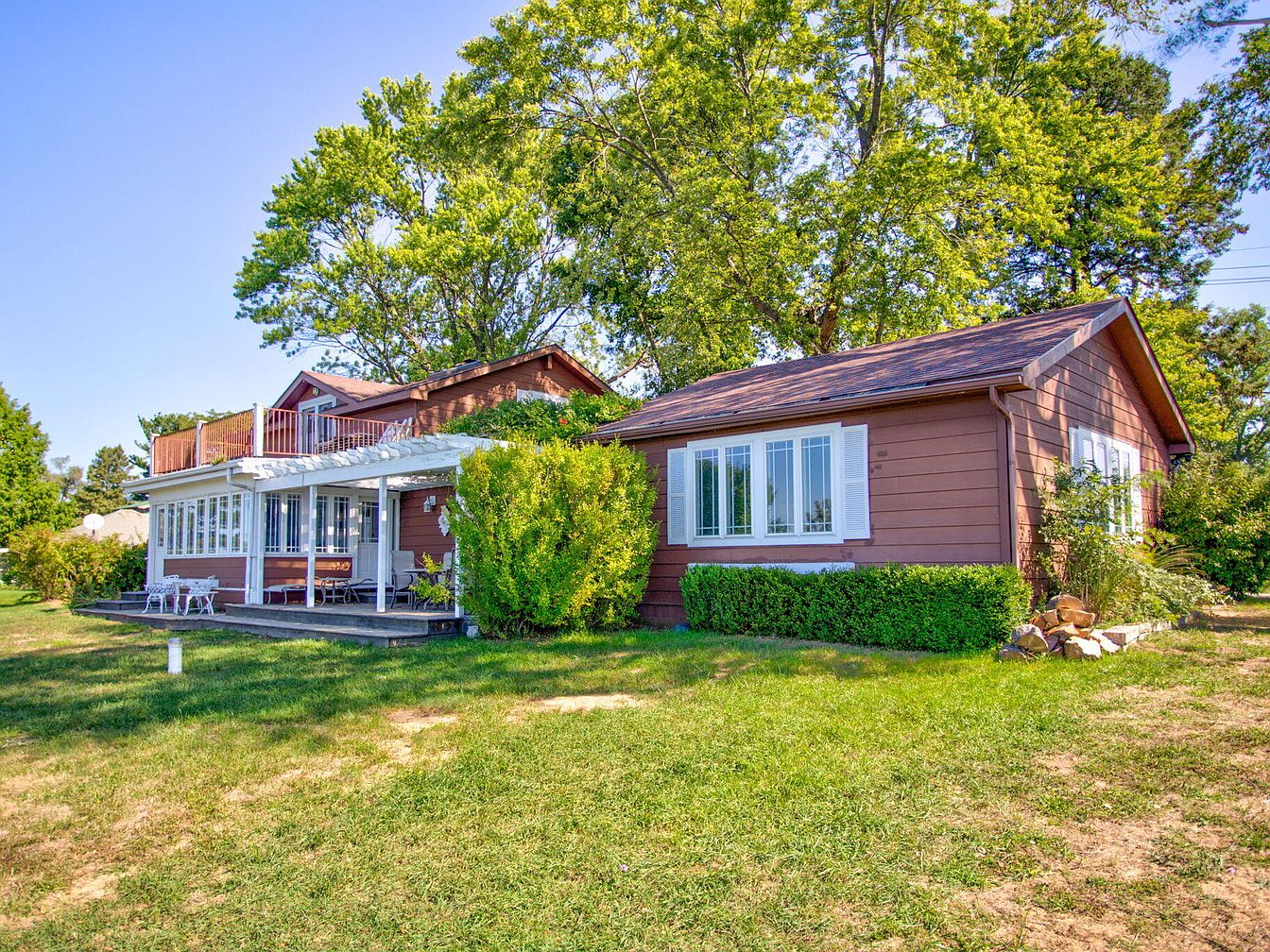 Charming 1930 Home in South Haven, Michigan, Featuring Expansive Decks for Sunset Views and Cozy Fireplace Gatherings