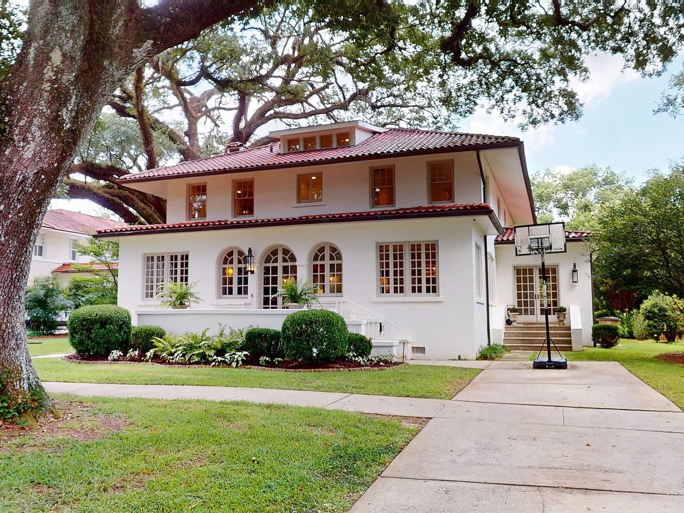 Timeless 1909 Spanish Masterpiece in Mobile, Alabama, Featuring Tile Floors, Living Spaces, and a Serene Outdoor Oasis