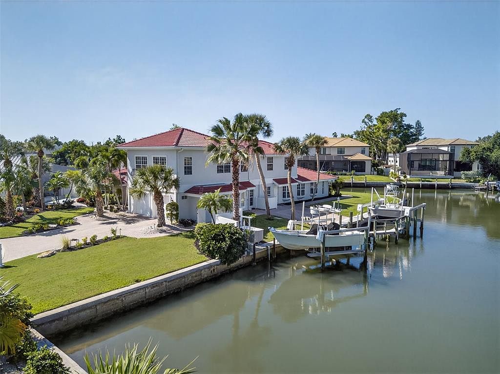 Amazing 1970 Waterfront Retreat in Sarasota, Florida with 268 Feet of Deep Water Docks and Expansive Outdoor Spaces