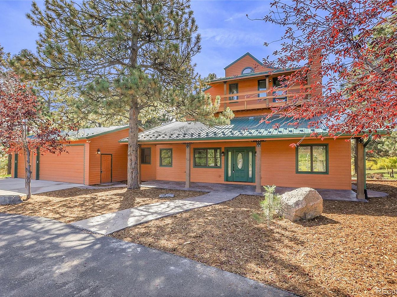 Discover a 1983 Mountain Retreat in Golden, Colorado with Custom-Built Staircases, a Sun-Filled Balcony, and a 0.83-Acre Lot