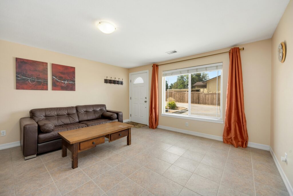 A leather sofa in a bright living room with visible stiffness and creasing caused by low indoor humidity
