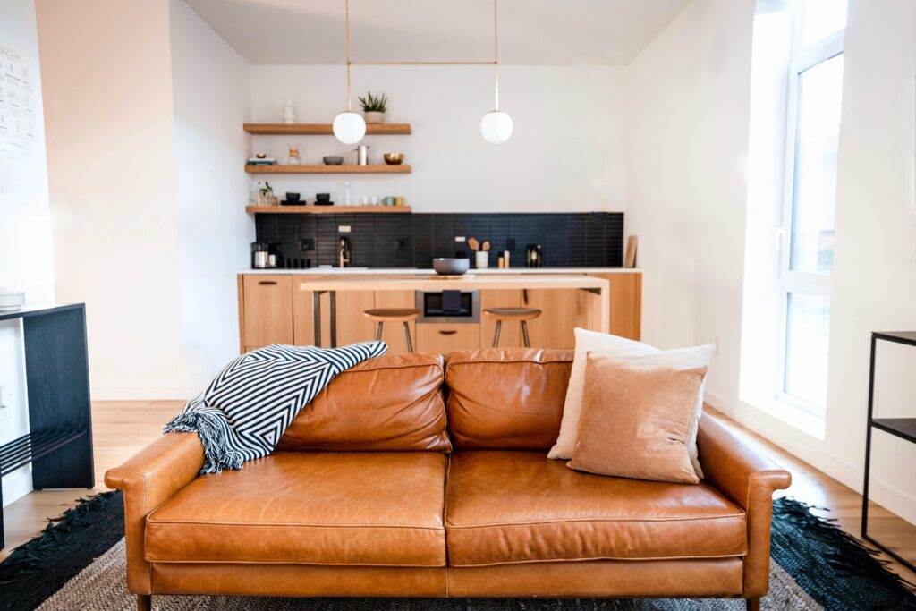 Leather conditioner and humidifier placed near a sofa to help prevent drying and cracking