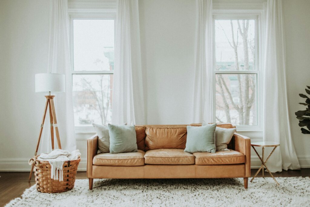 Sunlit leather sofa near a window, highlighting dryness and fading from heat and low humidity