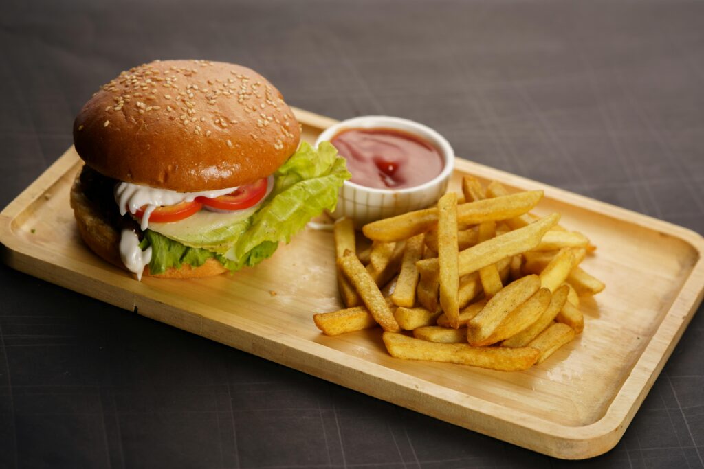 Classic cheeseburger with lettuce and tomato served with golden French fries