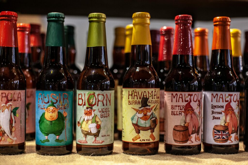 A selection of microbrew bottles from different states on a shelf, representing widely distributed craft beers