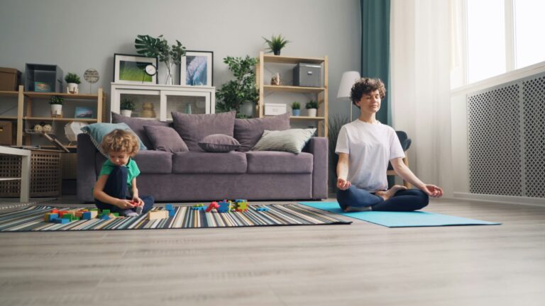 Toddler walking near colorful braided rugs in a family living room