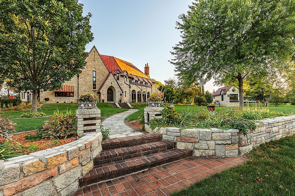 $2M English Manor in Winona, Minnesota, Featuring Hand-Chiseled Travertine, Four Stunning Fireplaces, and Lush Year-Round Gardens