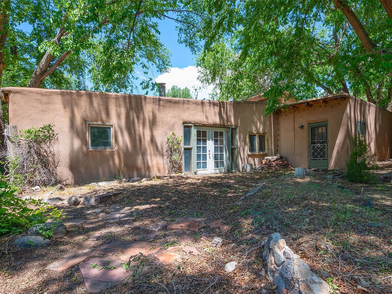 Historic 1919 Adobe Estate in Santa Fe, New Mexico with a 6-Acre Vineyard, Acequia Water Rights, and Endless Creative Possibilities