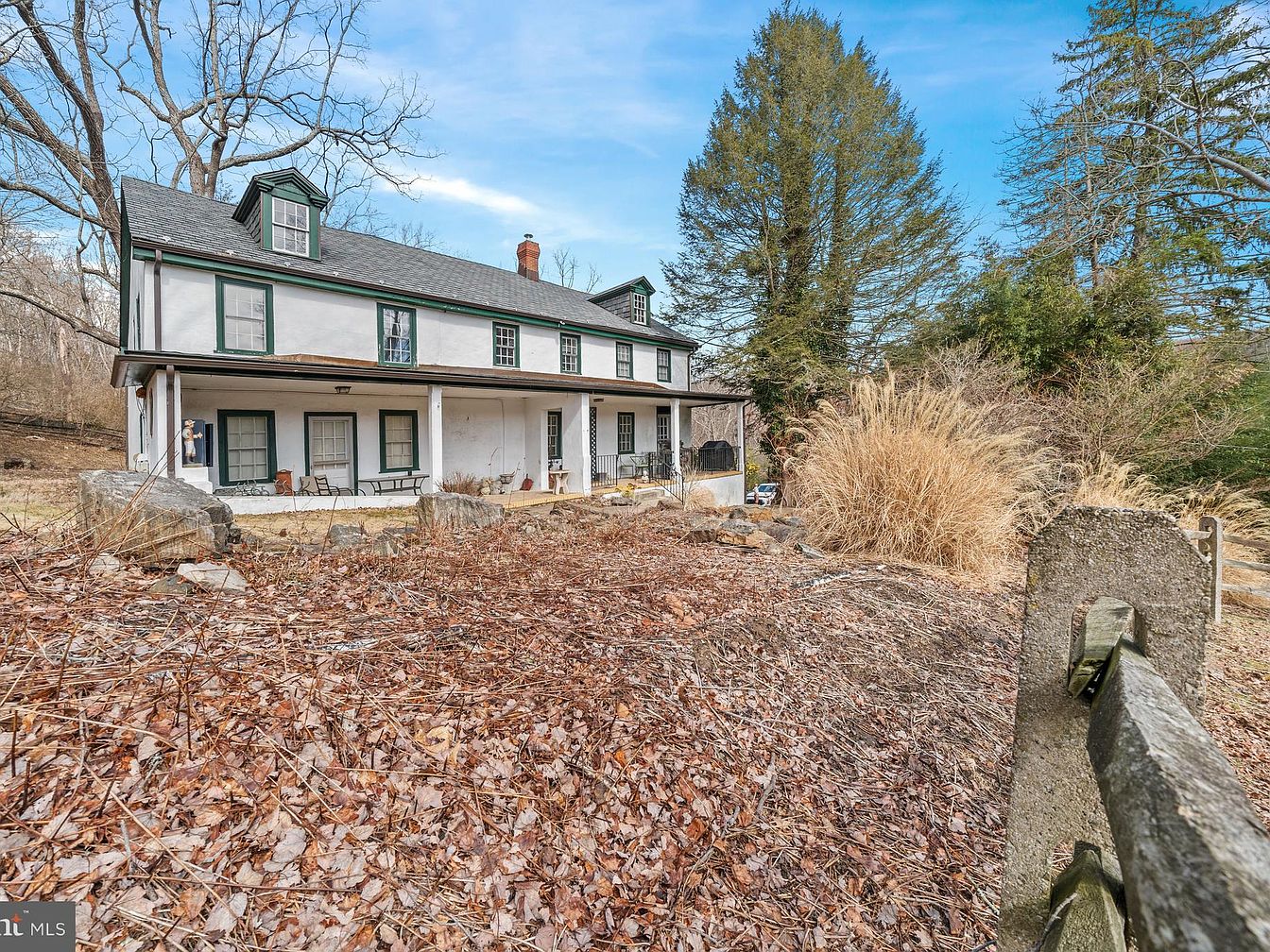 Charming 1900 Farmhouse in Wilmington, Delaware, Nestled on 36.8 Acres with Historic Features, Including a Large Front Porch and a Scenic Pond