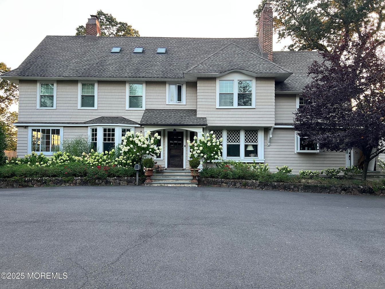 Luxurious Riverfront 1920 Home in Tinton Falls, New Jersey, with Sun-Drenched Interiors, Two Cozy Fireplaces, and Private Balconies