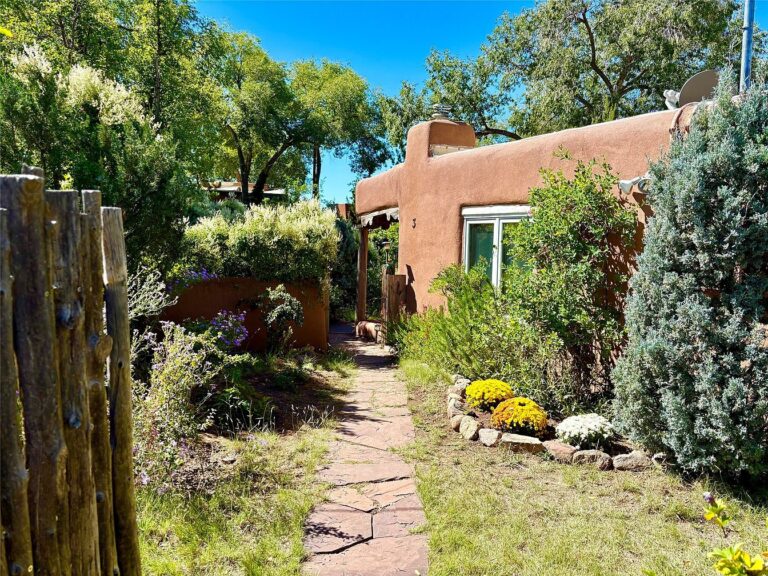 Historic 1917 Adobe Compound in Santa Fe, New Mexico, Featuring 8 Bedrooms, 9 Fireplaces, and Lush Landscaped Grounds on Two Acres