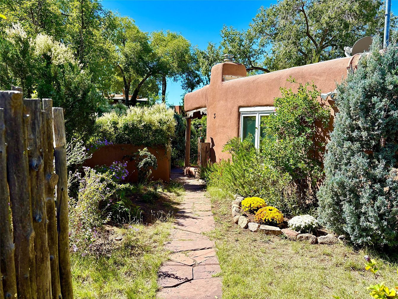 Historic 1917 Adobe Compound in Santa Fe, New Mexico, Featuring 8 Bedrooms, 9 Fireplaces, and Lush Landscaped Grounds on Two Acres