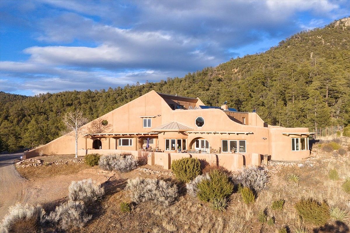 Stunning 1982 Adobe Estate in Santa Fe, New Mexico, Featuring 30 Hand-Carved Artistic Doors, Majestic Mountain Views on 78 Acres