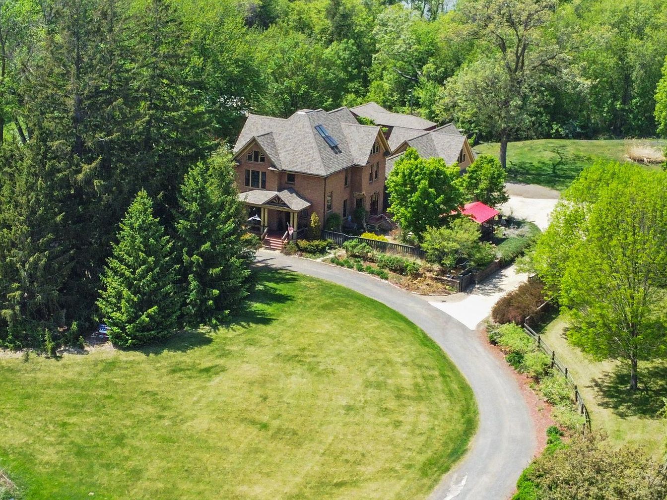 Timeless 1903 Farmhouse in Cambridge, Minnesota, Featuring 5 Bedrooms, Expansive Living Spaces, and 10 Acres of Scenic Beauty