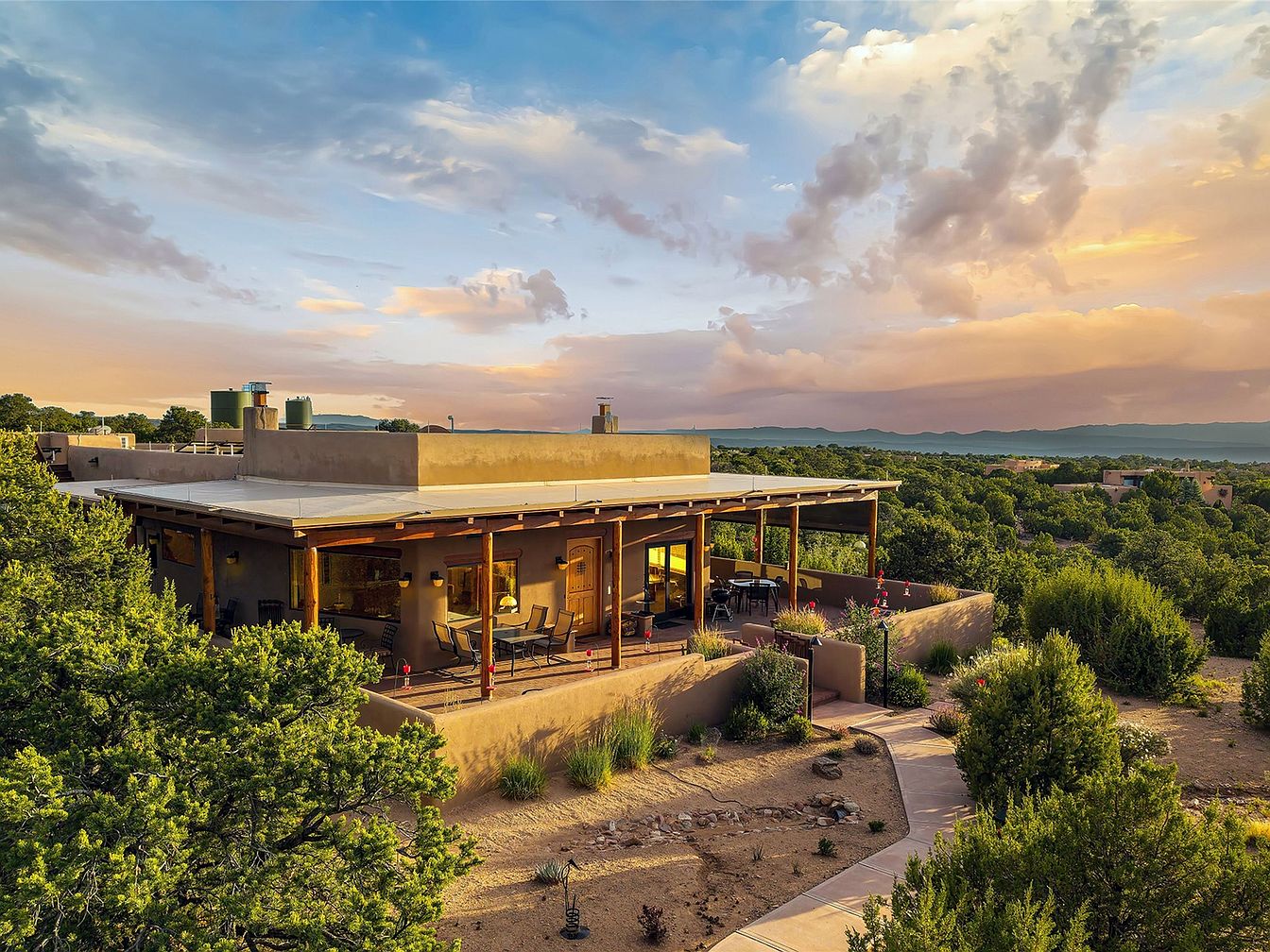 Experience a Stunning 2014 Santa Fe-Style Home in New Mexico with Panoramic Vistas, High Viga-Latilla Ceilings, and Beautifully Landscaped Gardens