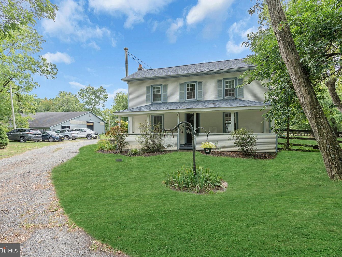 1907 Equestrian Retreat in Howell, New Jersey, Featuring 10.5 Acres, an Indoor Arena, and a Farmhouse with Rocking Chair Porch