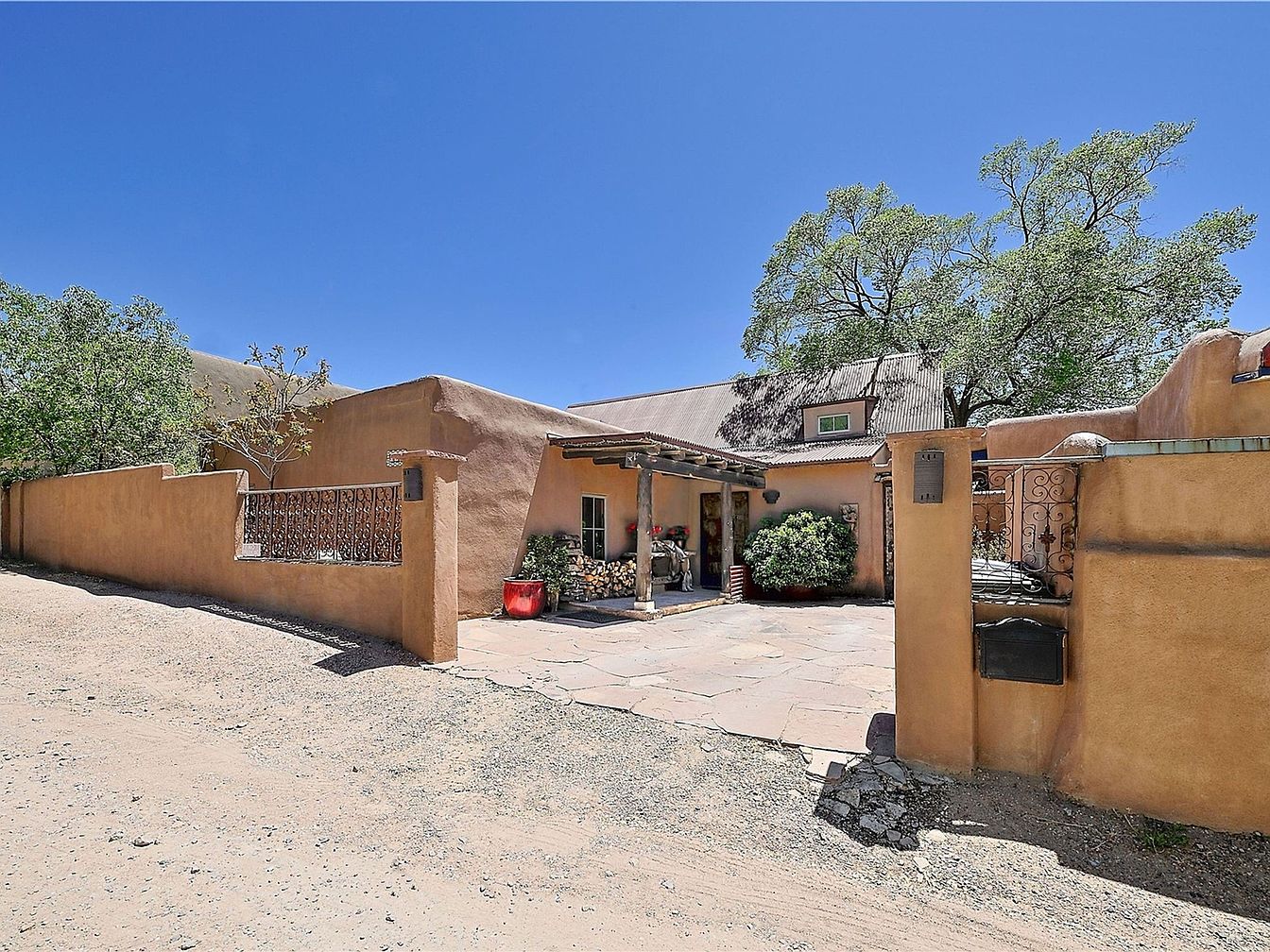 Charming 1963 Adobe Split-Level Home in Santa Fe, New Mexico with Exposed Vigas, Two Fireplaces, and a Beautifully Landscaped Patio