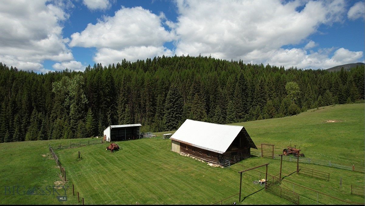 $3M Historic Log Home in Haugan, Montana, Featuring 80 Acres of Secluded Wilderness, a Charming Guest House, and a Vintage Barn