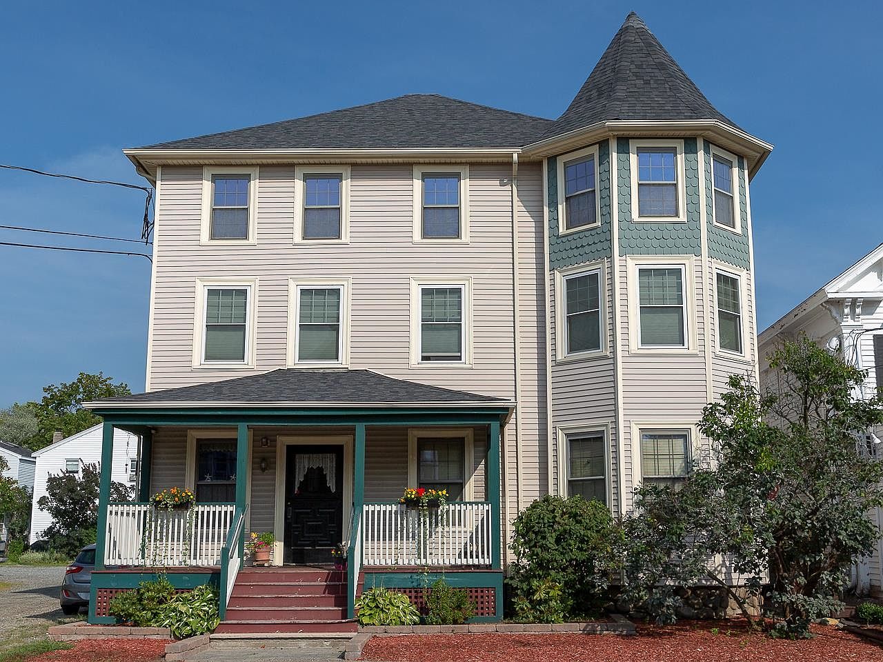 Historic 1900 Victorian Home in Hampton, New Hampshire, with Off-Street Parking and Versatile Garage on a Generous 0.42 Acre Lot