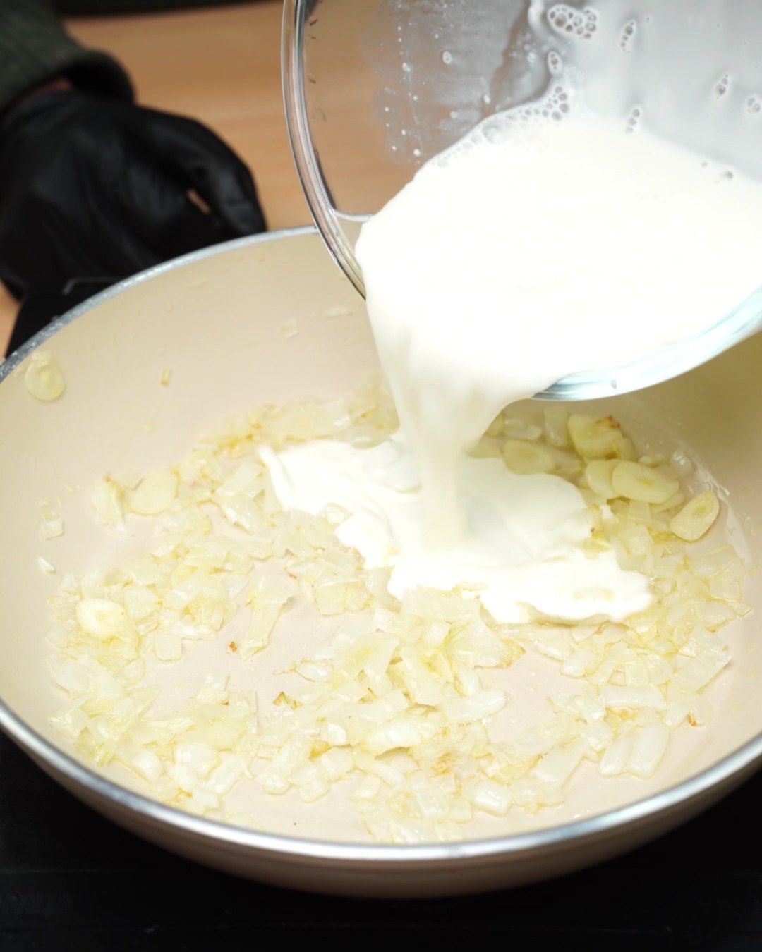 Heavy cream poured into the skillet