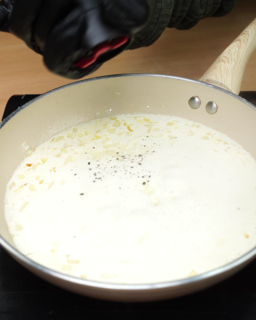 Black pepper ground over the garlic Parmesan sauce