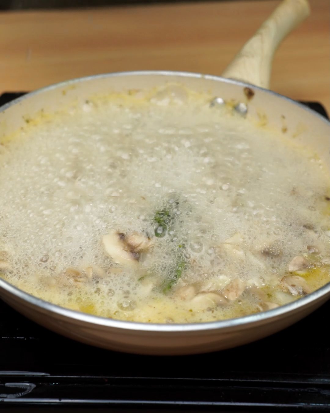 Mushrooms and rosemary simmering in bubbling broth