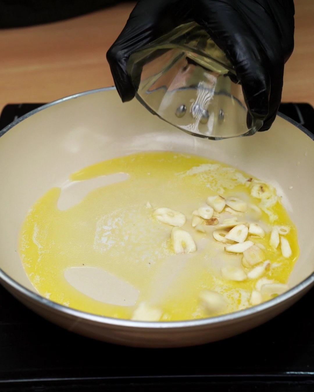 Sliced garlic added to melted butter