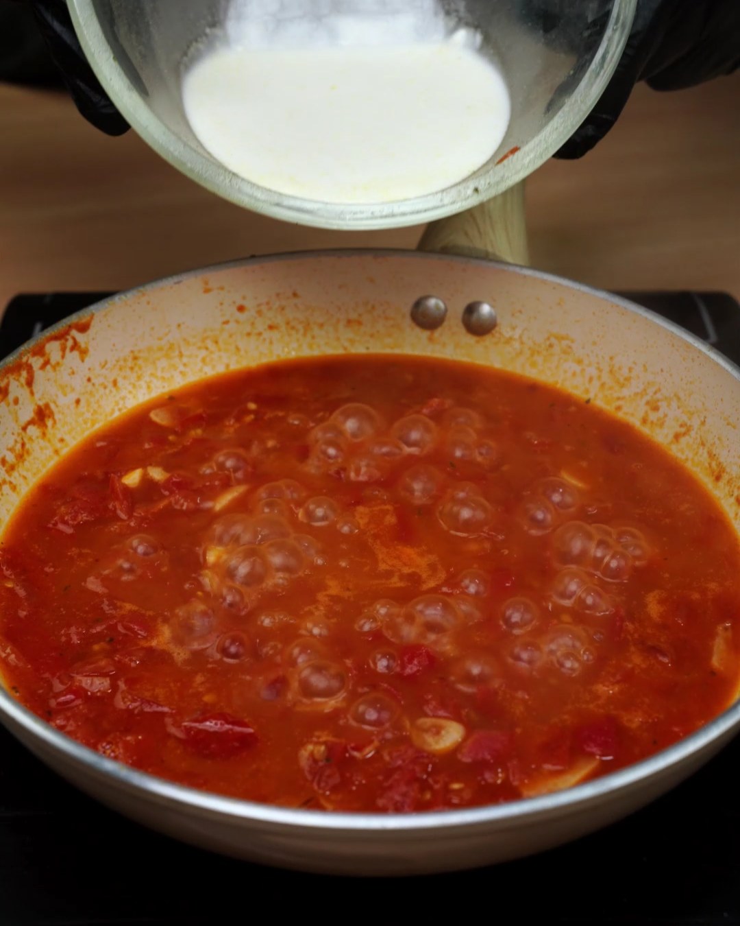 Tomato sauce simmering in the skillet