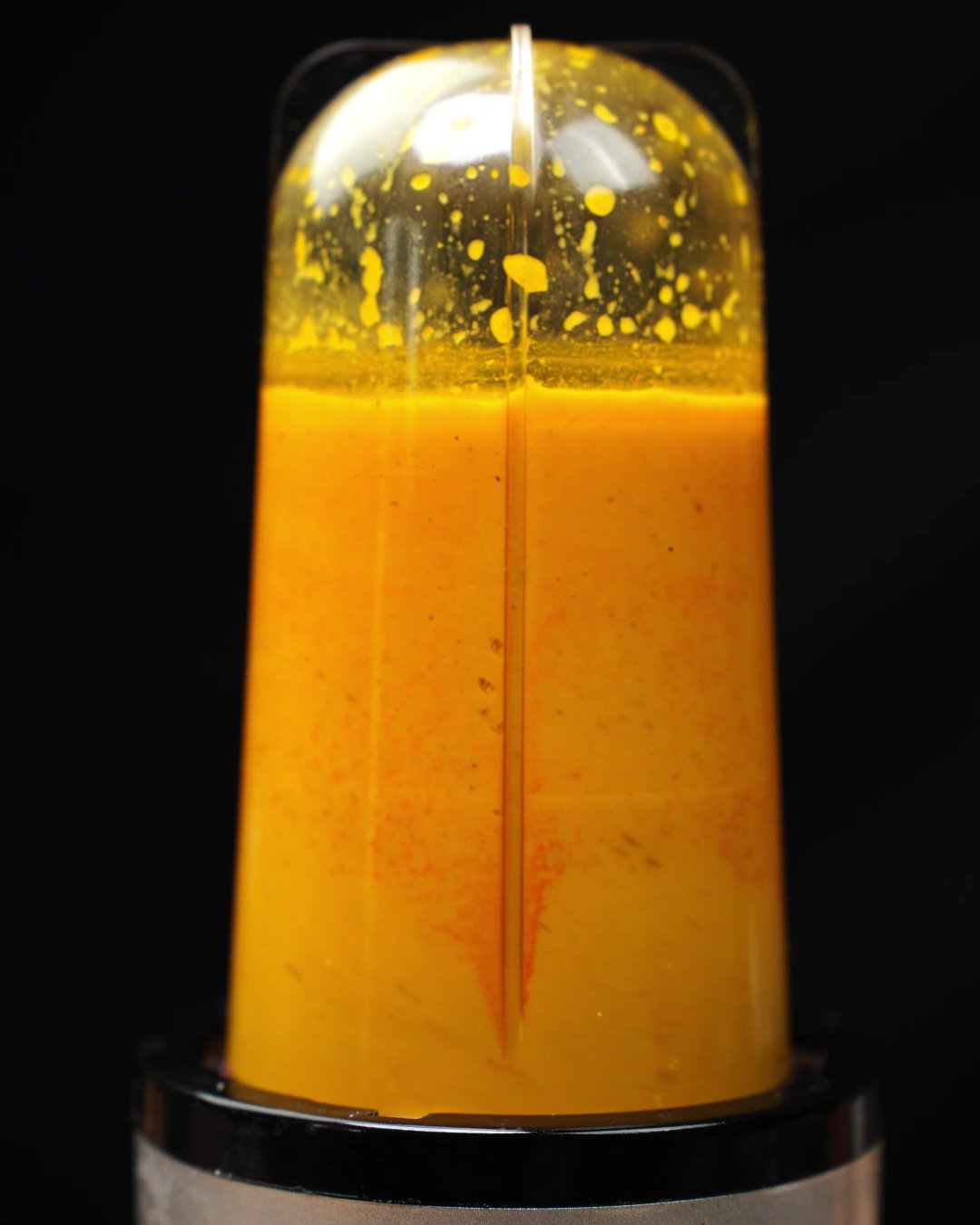 Smooth, creamy orange carrot soup in a blender