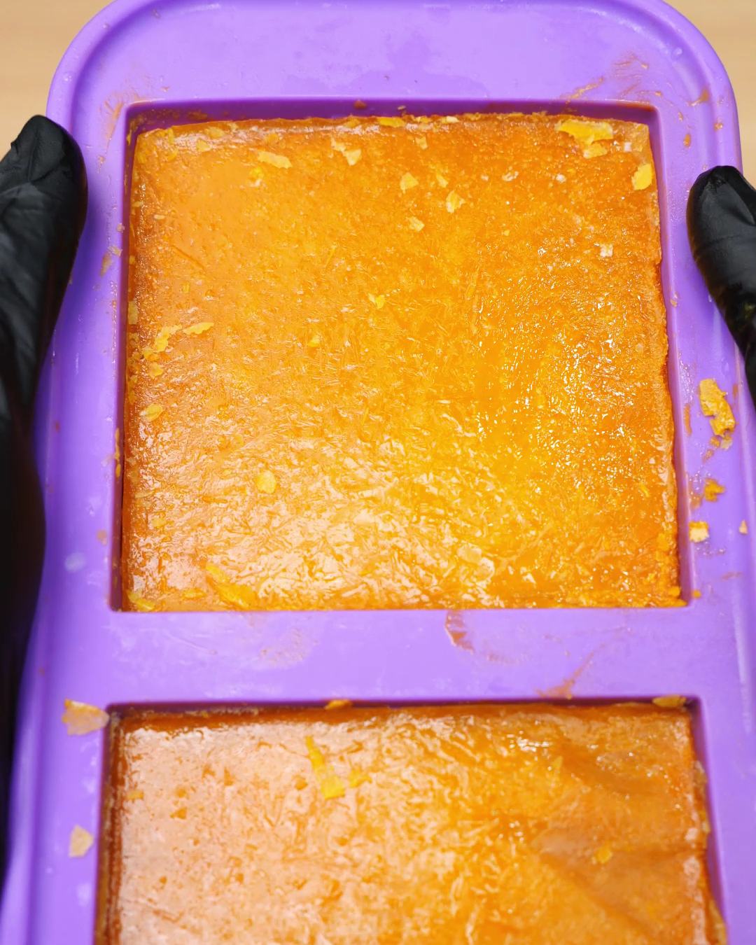 Frozen carrot soup blocks in a purple silicone freezer mold