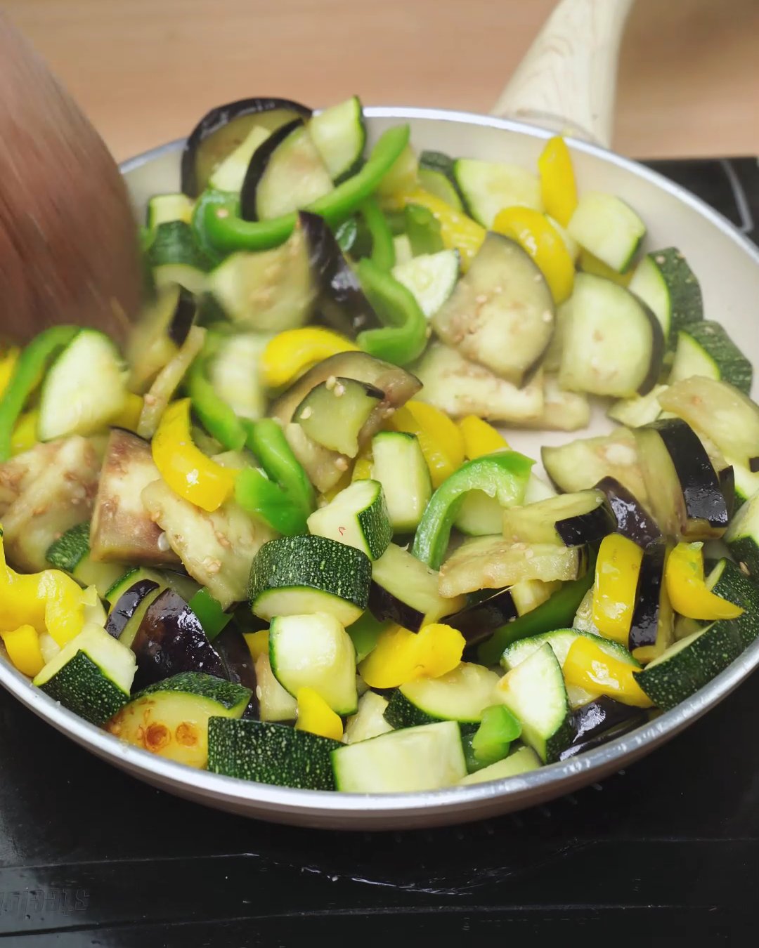 Zucchini, eggplant and bell peppers softened in a skillet